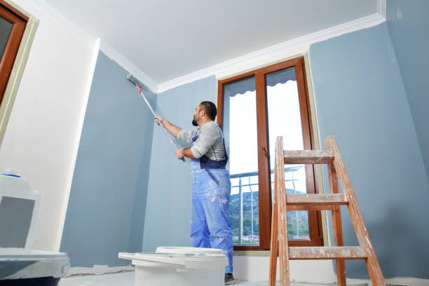 Painter man at work Painter man at work takes the color with paint roller from the bucket. With copy space drywall interior paiting stock pictures, royalty-free photos & images