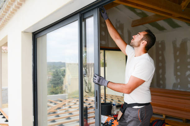 handsome young man installing bay window in a new house construction site handsome young man installing bay window in a new house construction site residential construction men stock pictures, royalty-free photos & images